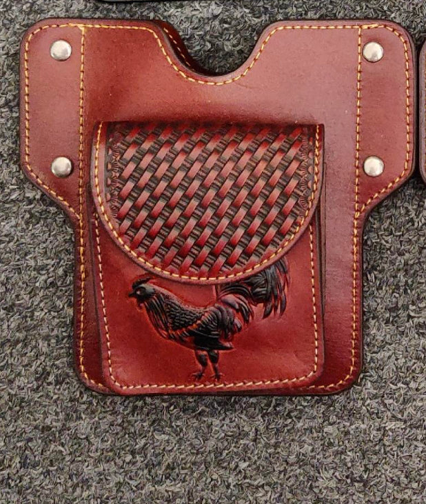 Brown leather holster with embossed Rooster design on a gray surface