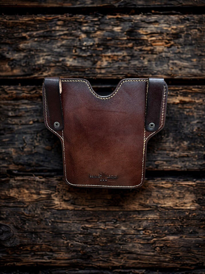Coffee Brown leather pouch on a wooden surface