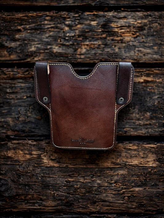 Coffee Brown leather pouch on a wooden surface