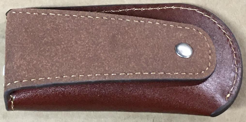 Brown leather knife sheath with a metal fastener on a beige background