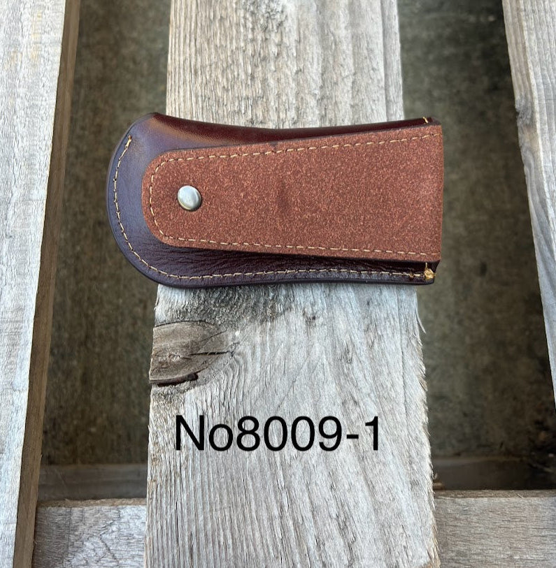A Coffee Brown leather knife sheath with a embossed Longhorn and Star design. Rear view showing leather belt loop. 