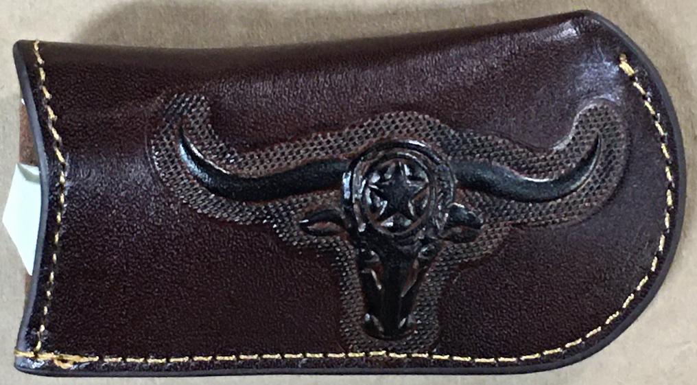 Coffee Brown leather wallet with black bull head emblem on a beige background