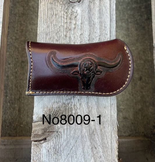 A Coffee Brown leather knife sheath with a embossed Longhorn and Star design. Front View