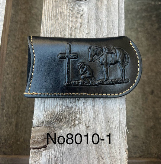 This Black leather knife sheath from Top Notch Accessories features an embossed Praying Cowboy design. Front View