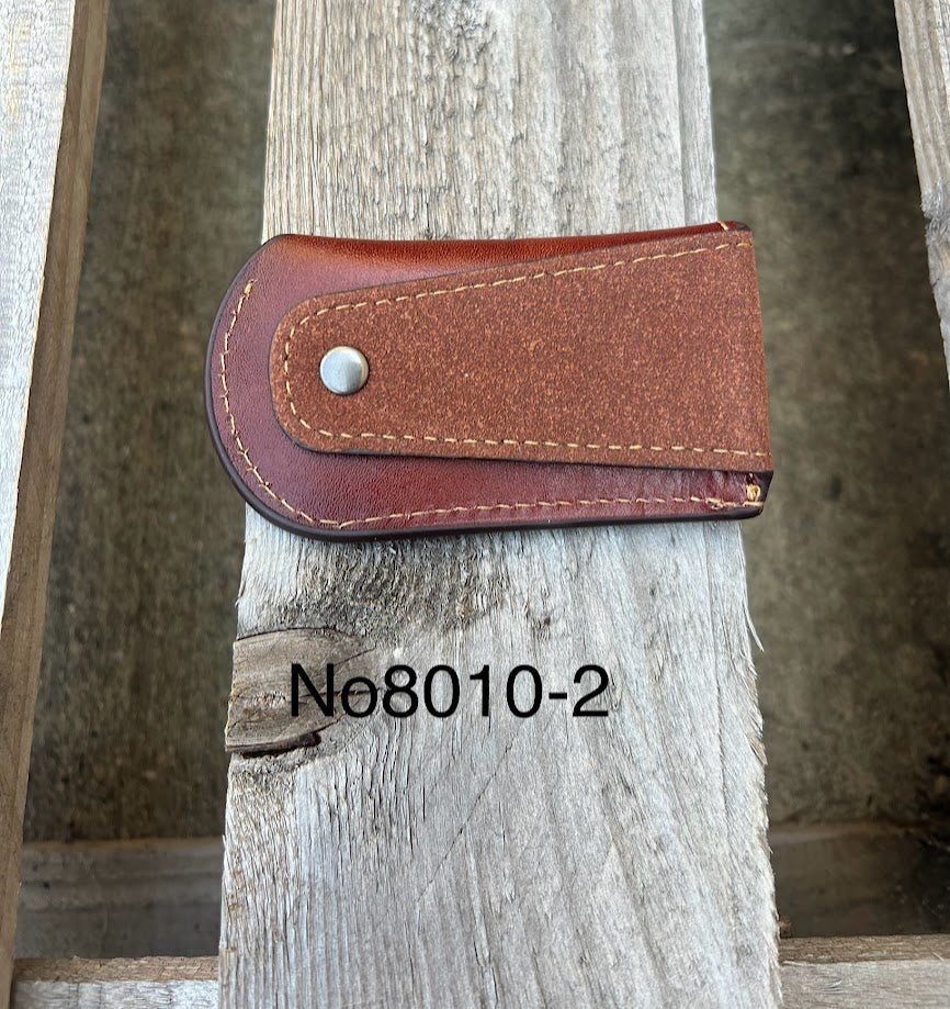 This Brown leather knife sheath from Top Notch Accessories features a embossed Praying Cowboy design. Rear view showing leather belt attachment. 