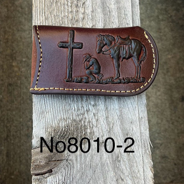 This Coffee Brown leather knife sheath features a embossed Praying Cowboy design. Front View