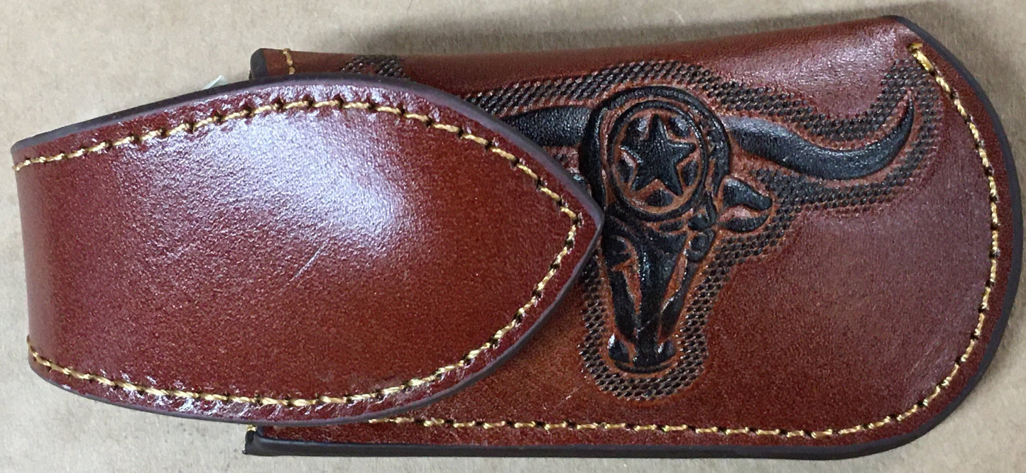 Brown leather knife sheath with a bull head emblem on a beige background