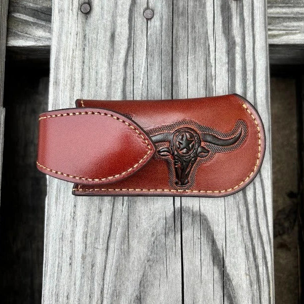 A brown leather knife sheath with a longhorn and star design. Front View