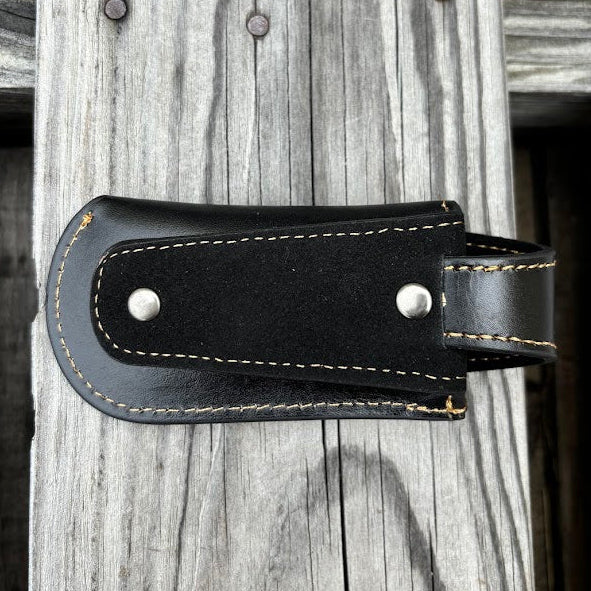 A black leather knife sheath with a keep, features a embossed design of a Praying Cowboy. Rear View showing belt loop attachment. 