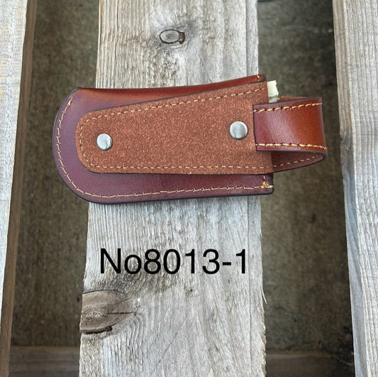 A brown leather knife sheath with a embossed Praying Cowboy. Rear view showing belt loop. 