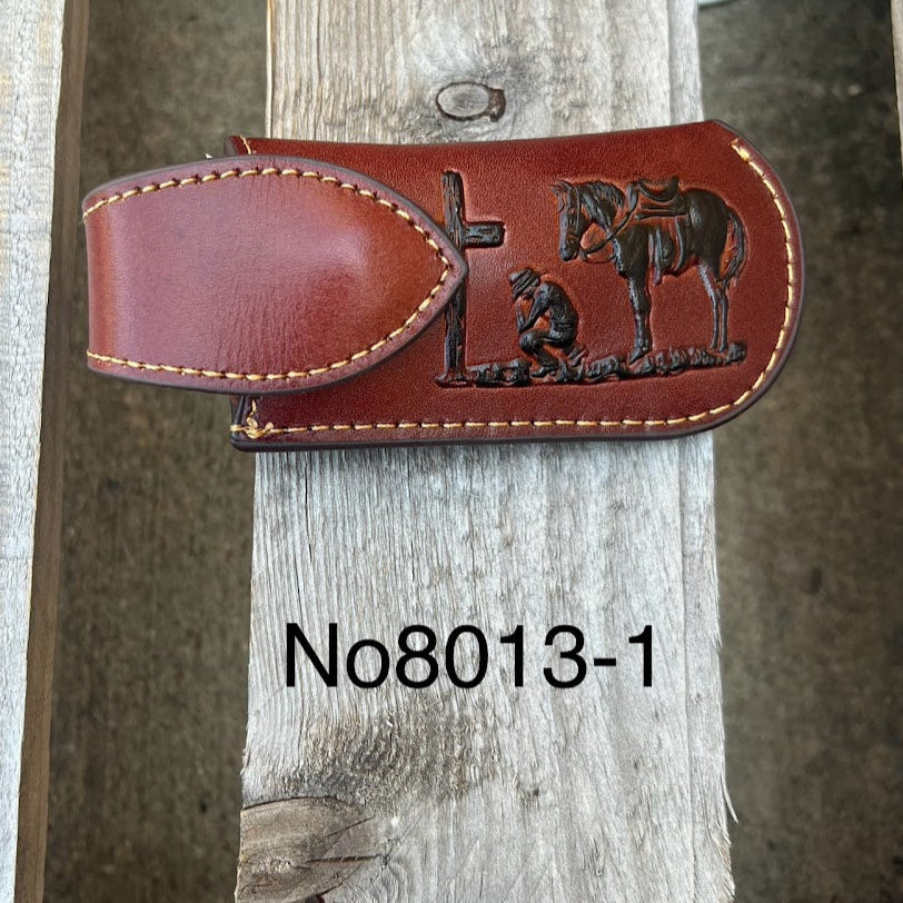 Brown leather sheath with embossed design on a wooden post, labeled 'No8013-1'. Front view.