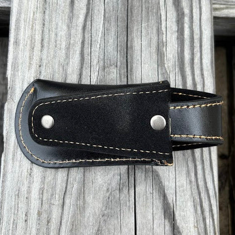 This Black leather knife sheath by Top Notch Accessories features a embossed Praying Cowboy design and has a keep for closure. Rear view showing leather belt loop. 