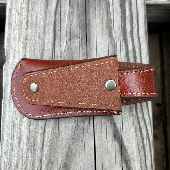 This Brown leather knife sheath with a Praying Cowboy design features a keep closure. Rear view showing the leather belt attachment. 