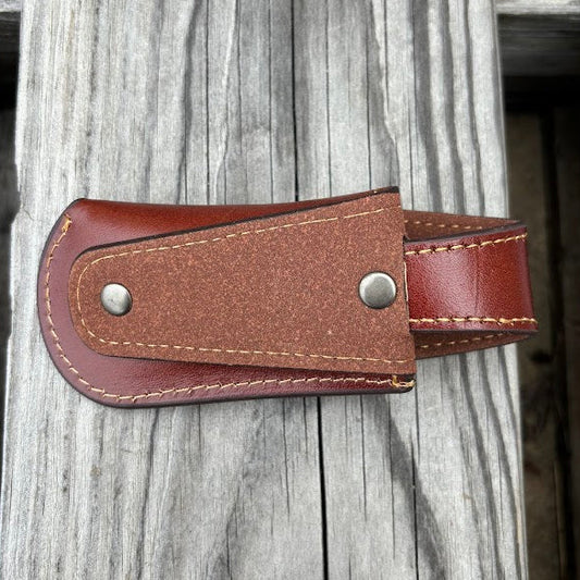 This Brown leather knife sheath with a Praying Cowboy design features a keep closure. Rear view showing the leather belt attachment. 