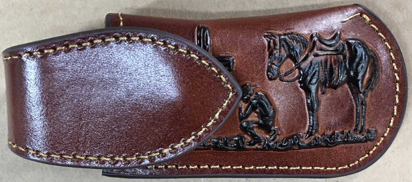 Brown leather sheath with embossed design of a horse and rider on a beige background