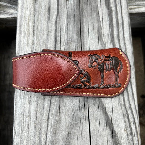 This Brown leather knife sheath with a Praying Cowboy design features a keep closure. 