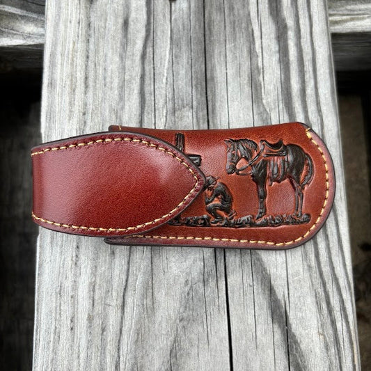 This Brown leather knife sheath with a Praying Cowboy design features a keep closure. 