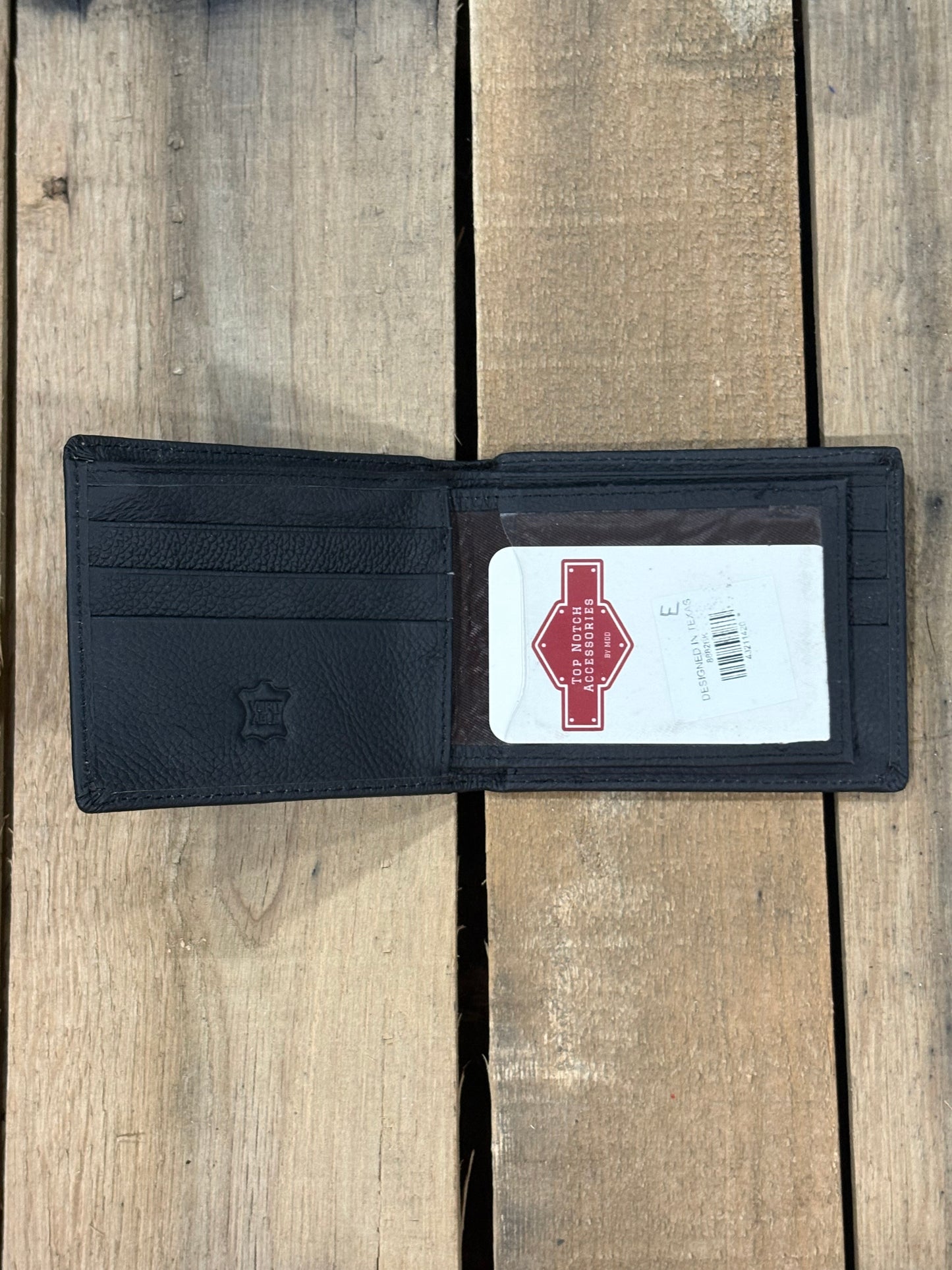 Black smooth leather bifold wallet from Top Notch Accessories. Inside view showing four card slots with a a ID window, and two bill slots one zips closed.