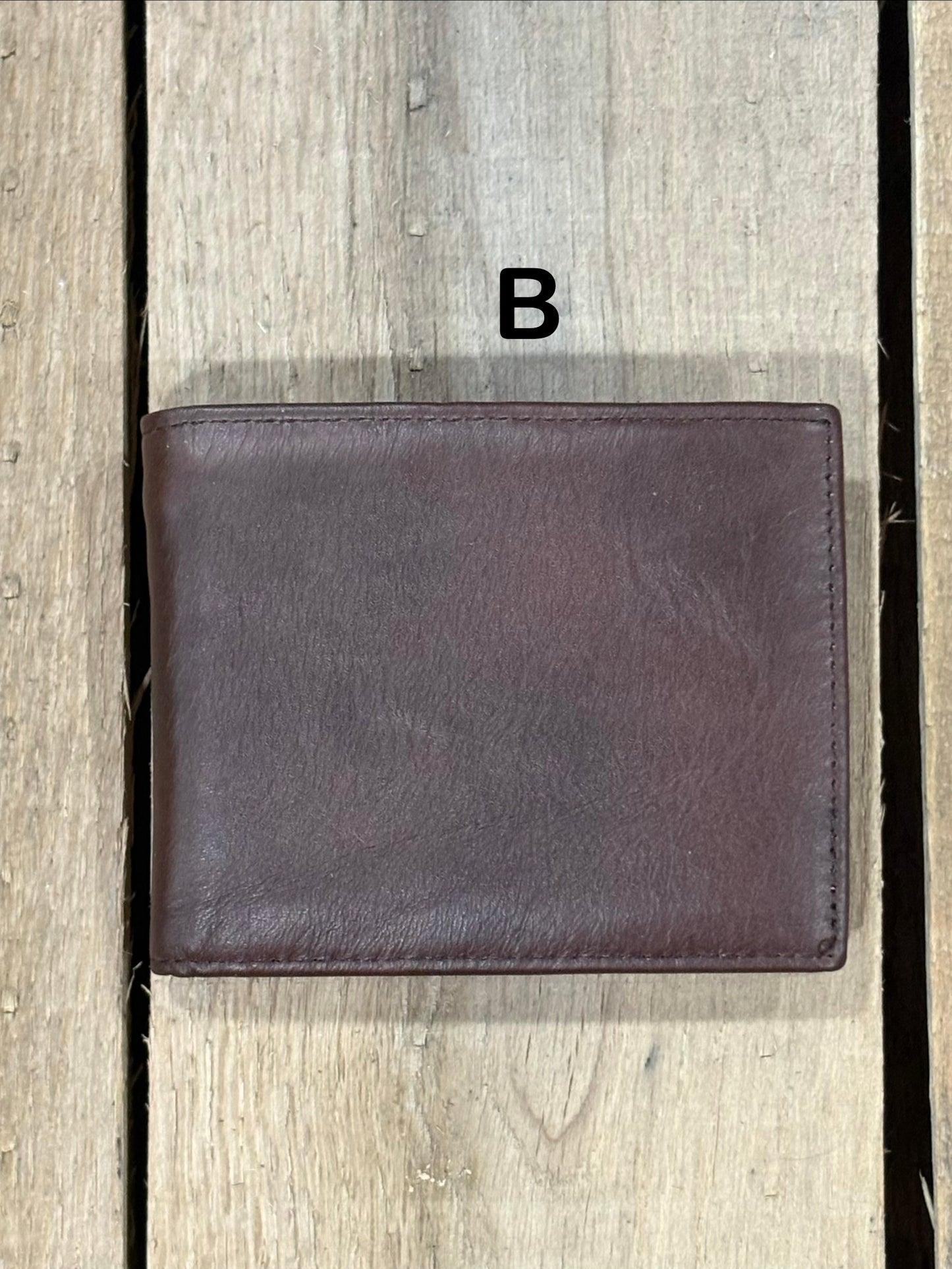 Dark Brown smooth leather wallet on a wooden surface