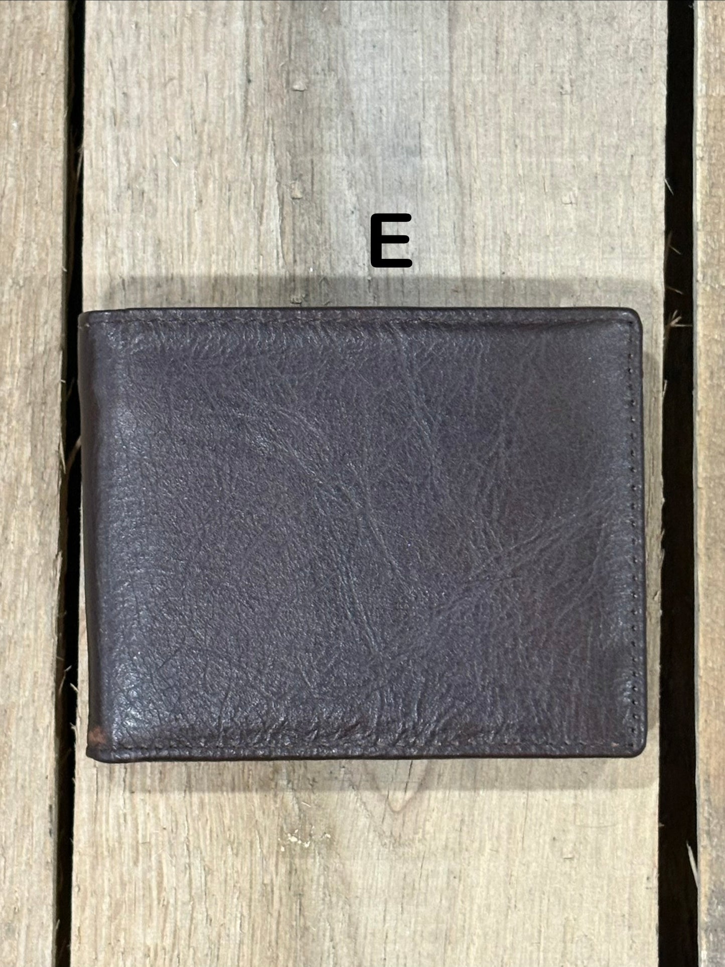 Dark Brown smooth leather wallet on a wooden surface