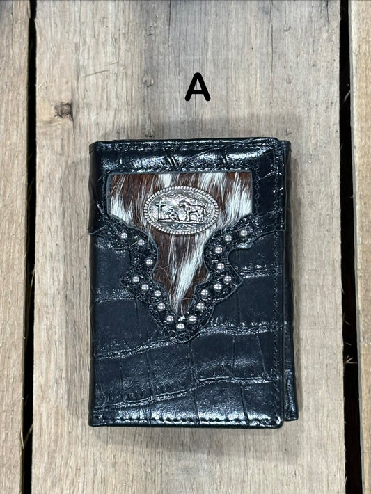 Black leather alligator print wallet with black and white hairon cowhide, praying cowboy concho on a wooden surface