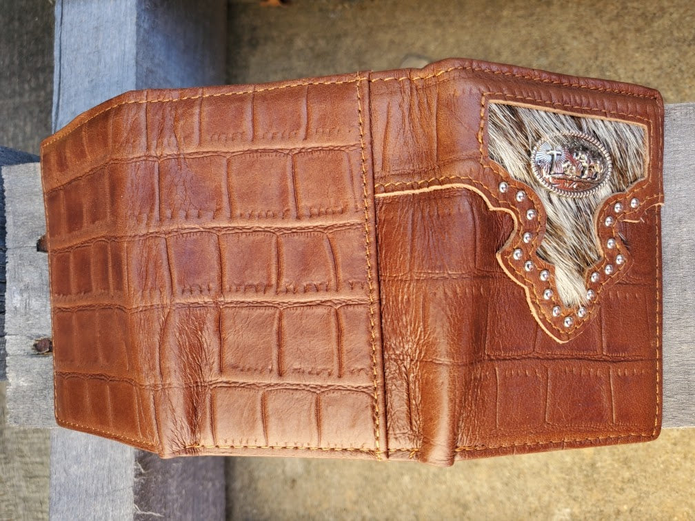Brown alligator print leather trifold wallet with a Praying Cowboy Concho on a cowhide inlay. Rear view showing a close up of the alligator print leather. 