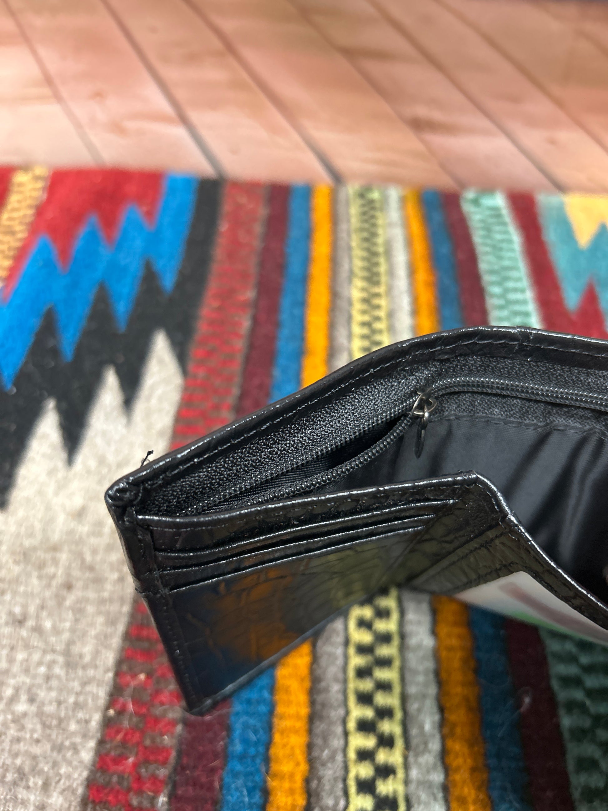 Black alligator print leather trifold wallet with a cowhide inset featuring a Rooster Concho. Interior view of cash slot showing zip closure. 