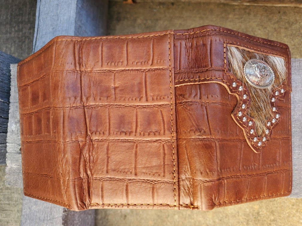 Brown alligator print leather trifold wallet with a Praying Cowboy Concho on a cowhide inlay. Rear view showing a close up of the alligator print leather. 