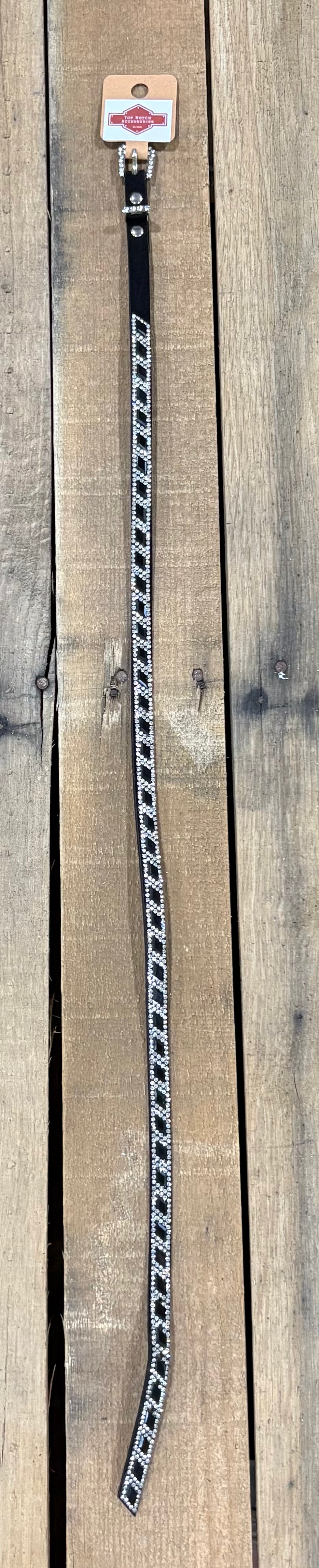 Long black hat band with black diamond sequence on a wooden surface
