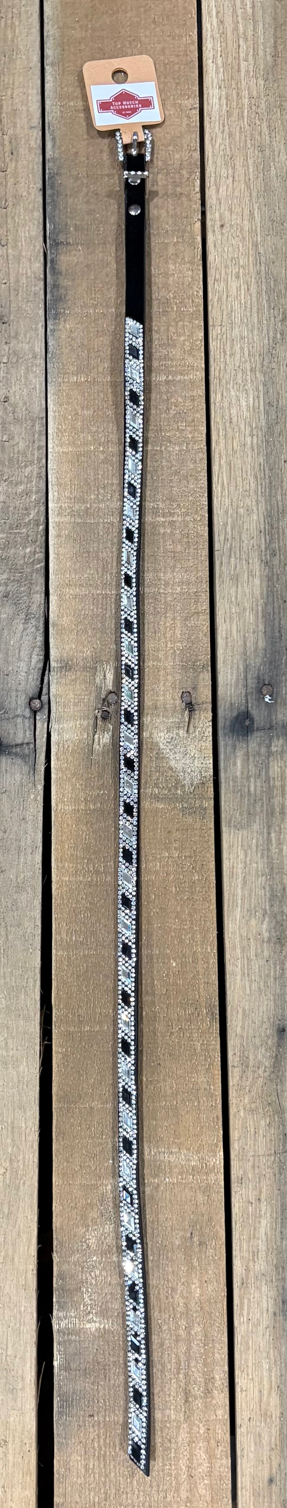 Long black hat band with black and clear diamond sequence on a wooden surface