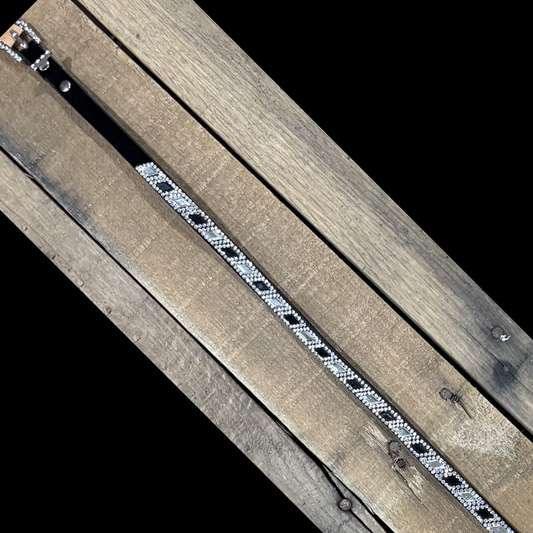 Long black hat band with black and clear diamond sequence on a wooden surface