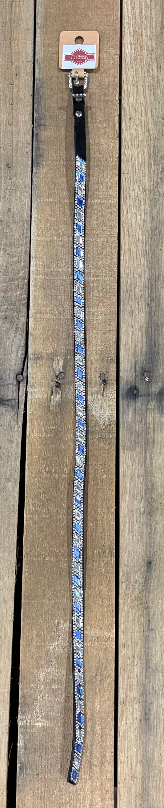 Long black hat band with clear and blue diamond sequence on a wooden surface
