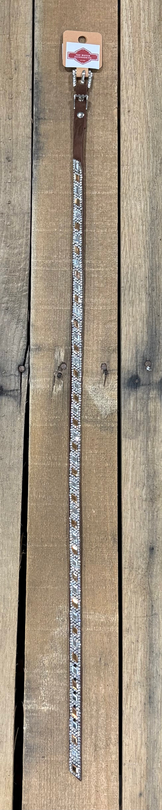 Long coffee brown hat band with clear and brown diamond sequence on a wooden surface
