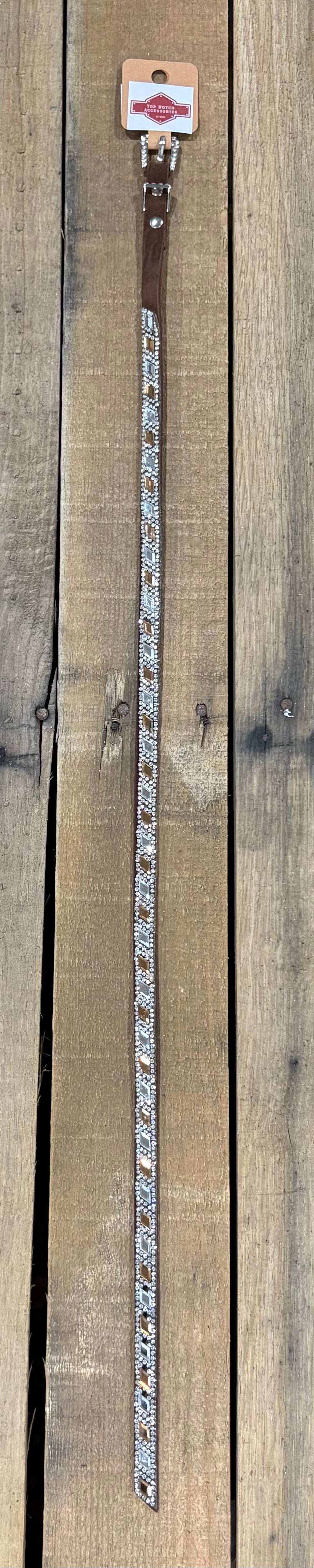 Long coffee brown hat band with clear and brown diamond sequence on a wooden surface