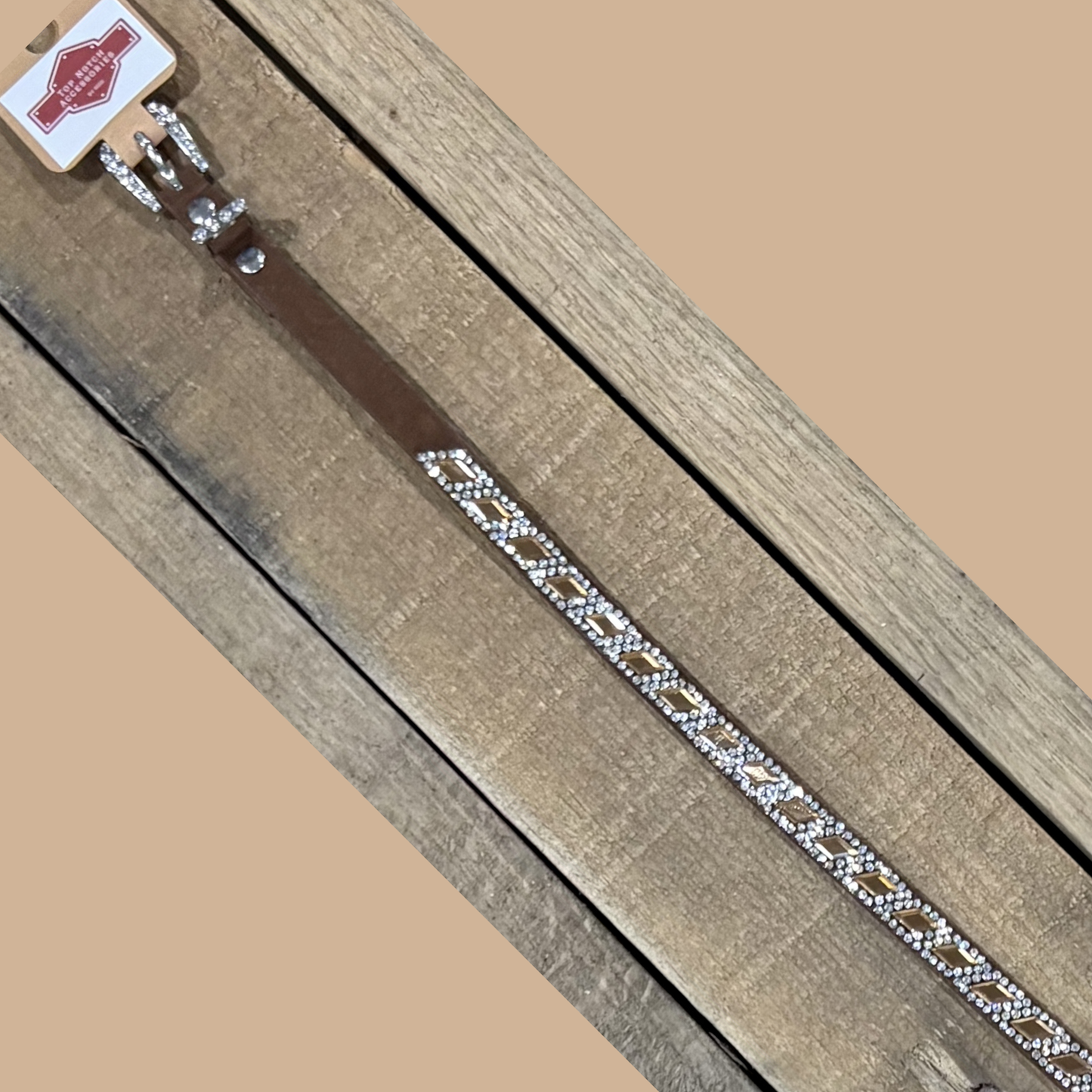 Long coffee brown hat band with brown diamond sequence on a wooden surface