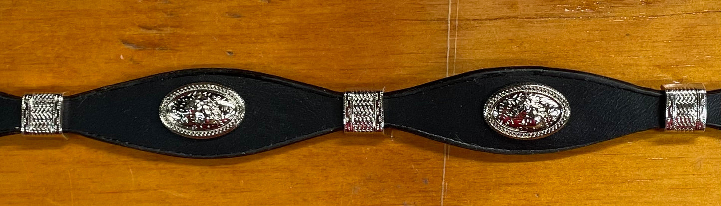 Black leather hat band with a Horse Head Concho with silver bands separating them. This hat band is fully adjustable with a Western style buckle. On wooden background.