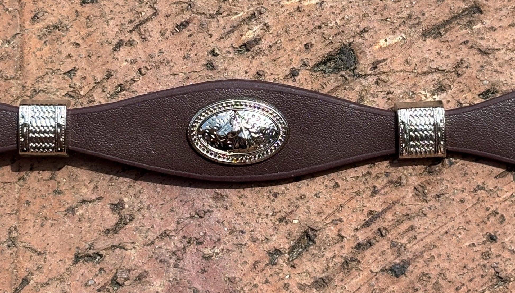 Coffee Brown leather hat band with Horse Head Concho and silver bands separating Conchos. 