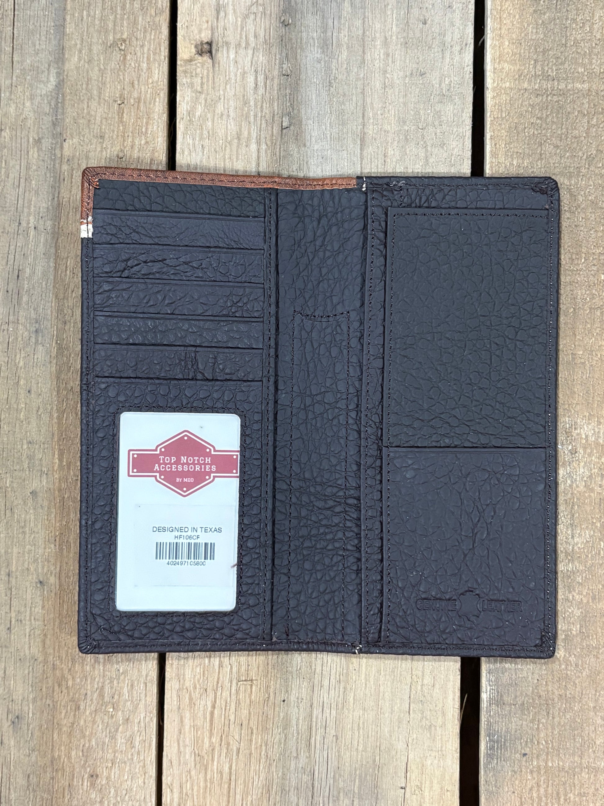 Coffee Brown leather wallet with a visible brand label inside view on a wooden surface