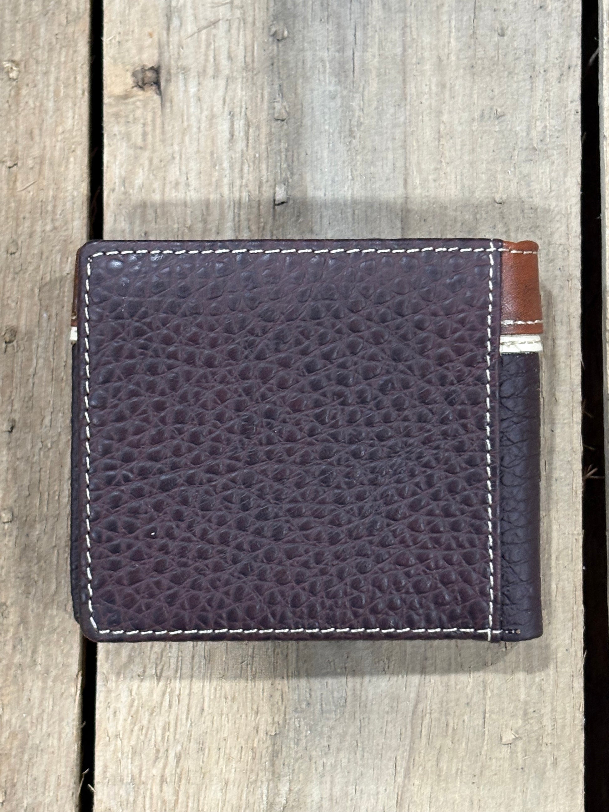Coffee Brown pebbled leather wallet with visible stitching on a wooden surface