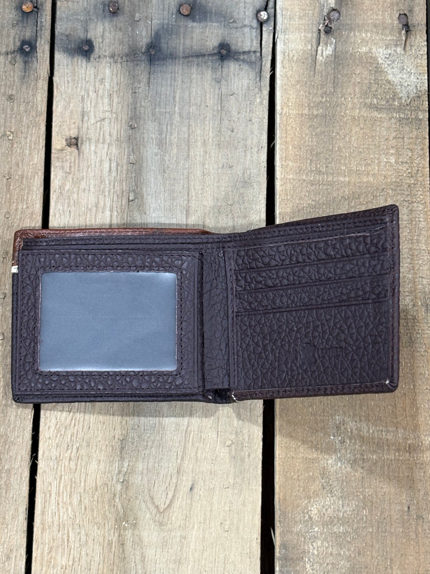 Coffee Brown pebbled leather wallet with three card slots and a ID window slot a brand label on a wooden surface