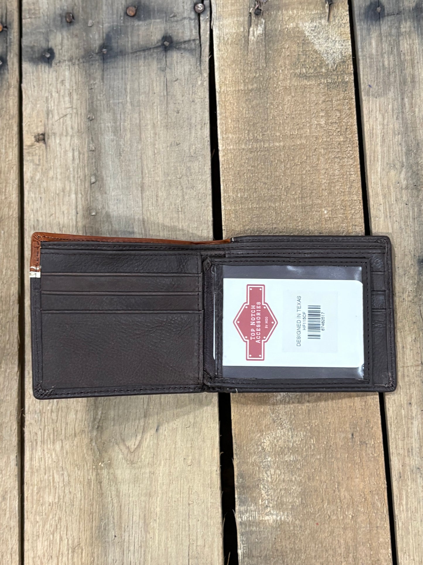 Coffee Brown leather wallet with a Top Notch Accessories card inside the ID window slot and 3 card slots on a wooden surface