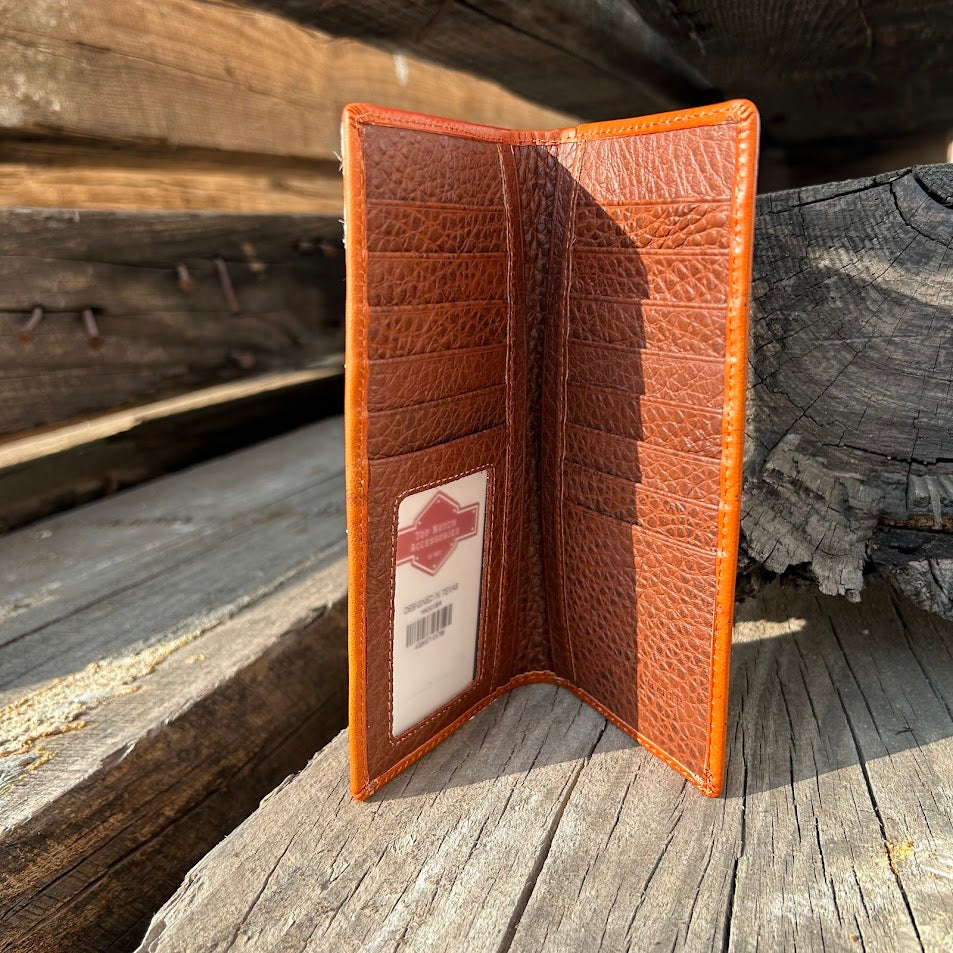Brown textured wallet with a brand label on a wooden surface