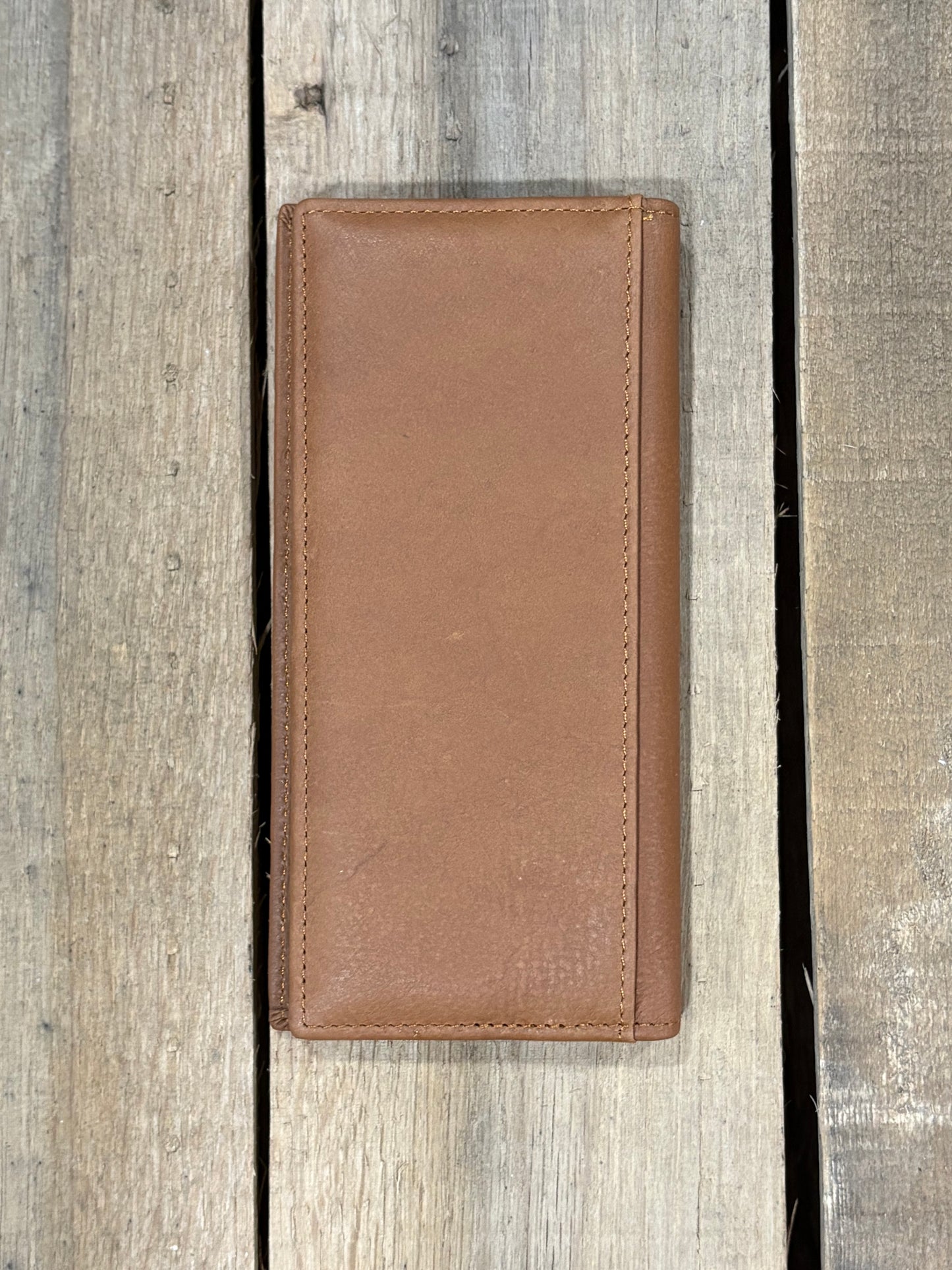 Back view of brown leather wallet on a wooden surface