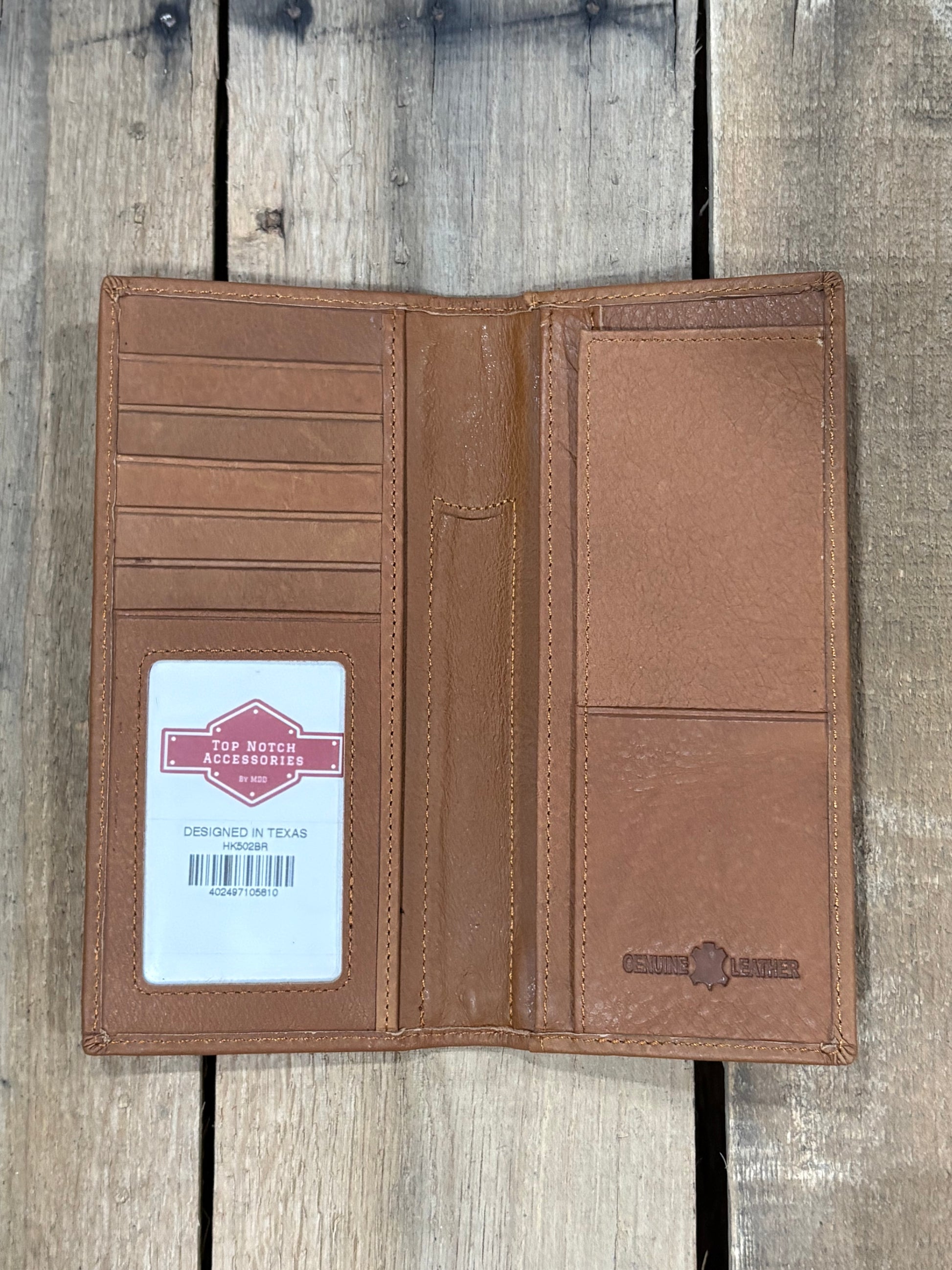 Brown leather wallet with a visible brand label on a wooden surface