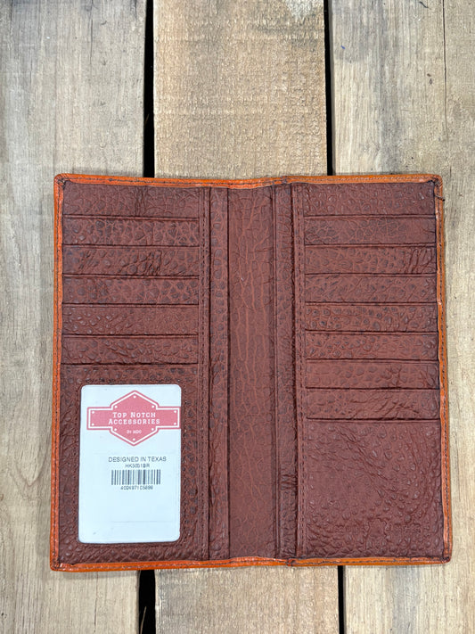 Brown leather wallet with a label on a wooden surface