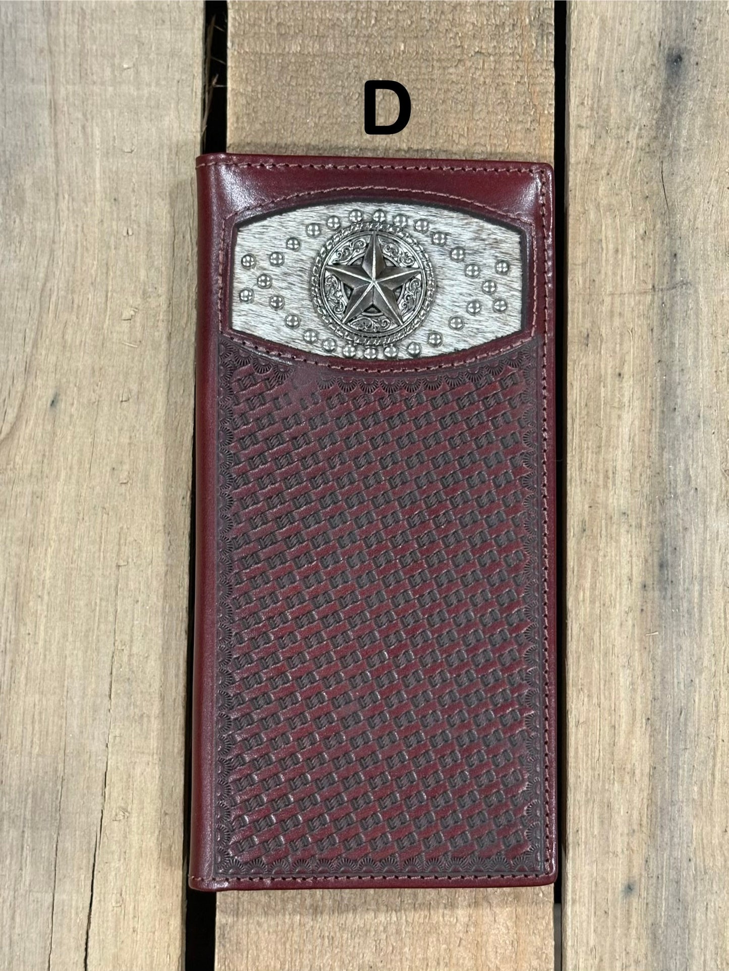 Coffee Brown leather wallet with star silver concho with embossed basketweave design on a wooden surface