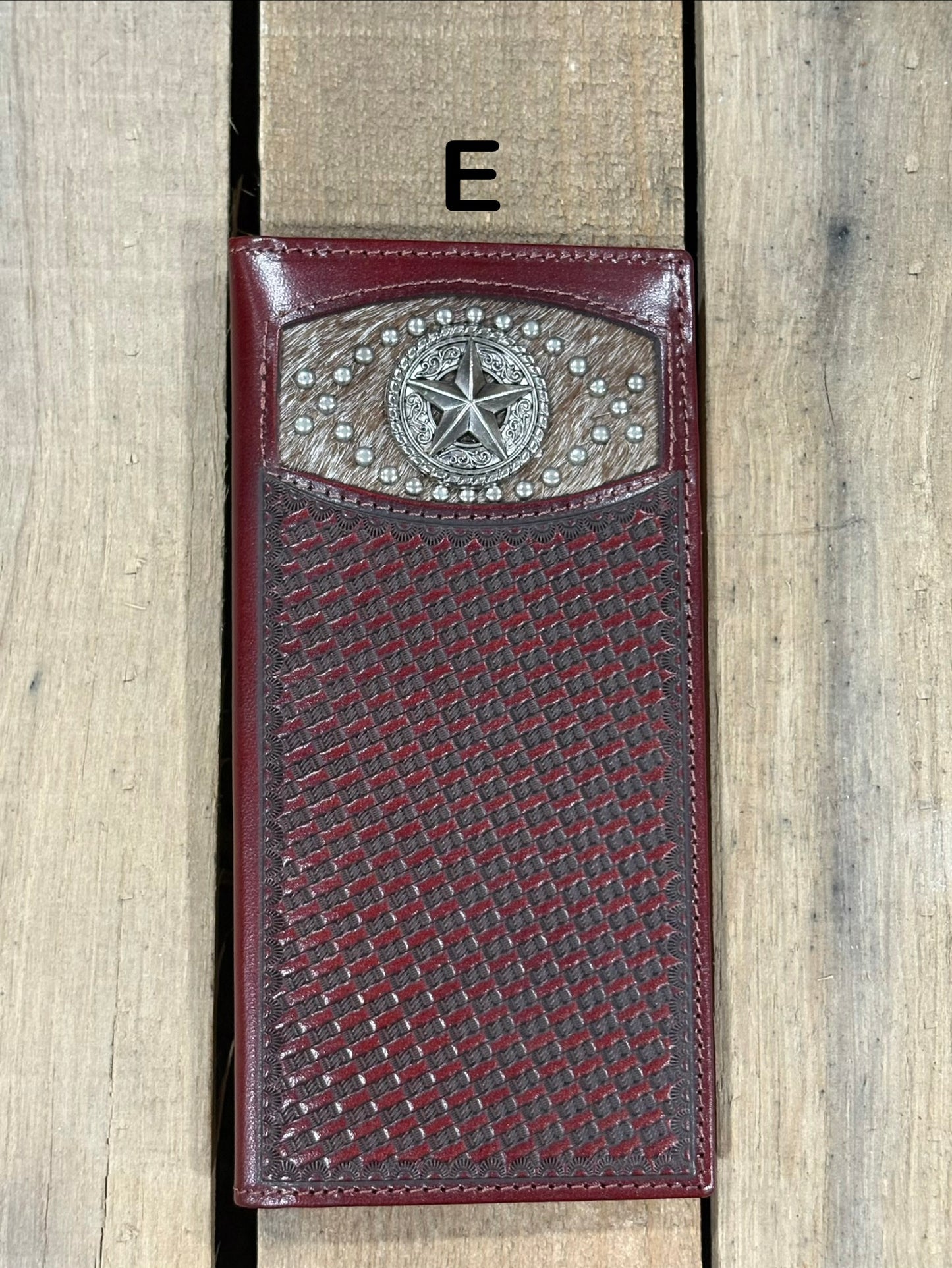 Coffee Brown leather wallet with star silver concho with embossed basketweave design on a wooden surface