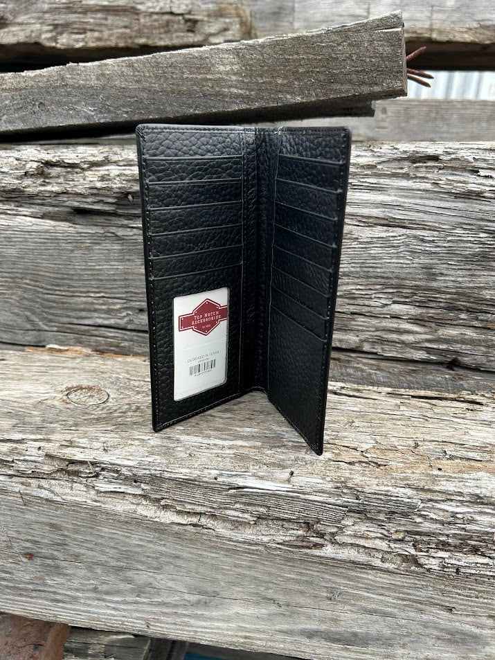 Black leather wallet open on a wooden surface with a visible brand label.