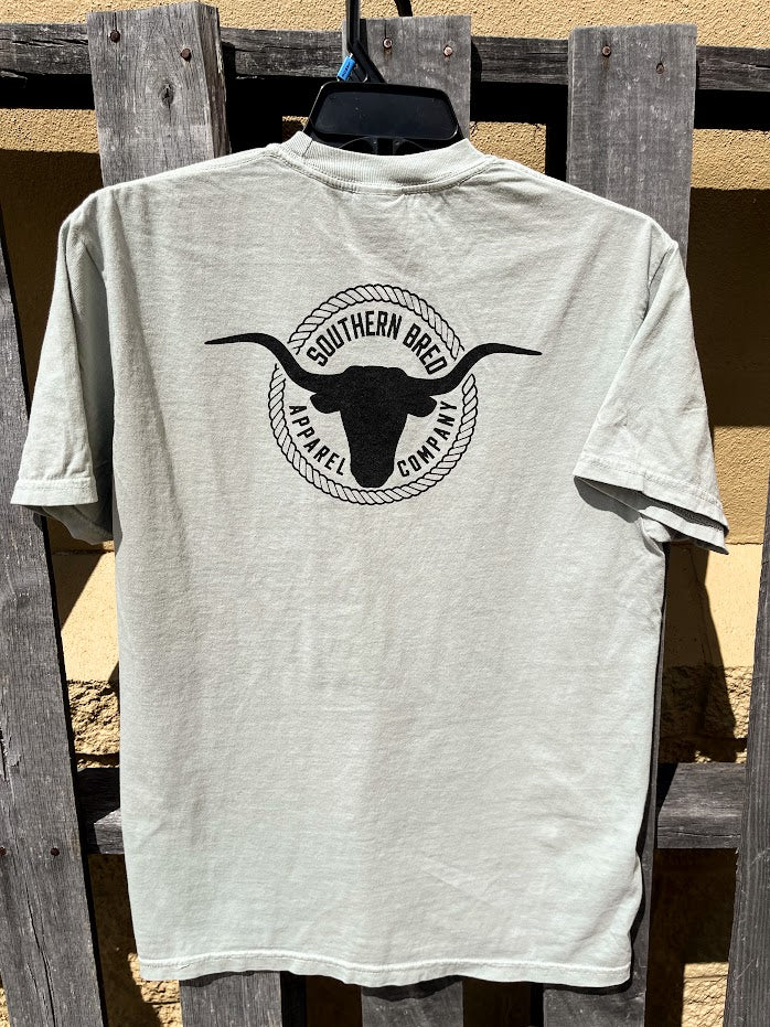 Bay t-shirt with a black logo on a wooden background