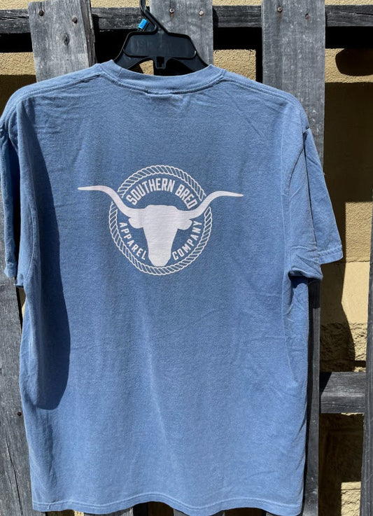 Blue Jean t-shirt with a white logo on a wooden background